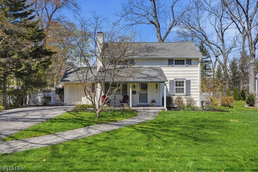 Welcome to this oh-so-charming 4 bed, 2 bath colonial/cape that will have you at "hello"! An open front porch leads into a spacious living room with wood-burning fireplace and plenty of space to socialize and host intimate gatherings. An adjoining family room is perfect for lounging and catching up on the latest shows. The home chef's kitchen is equipped with stainless steel appliances, abundant cabinet storage, and plenty of counter space for meal prep. A convenient walk-out to the attached deck makes for great summertime al fresco dining. The formal dining room easily accommodates nightly dining and special occasions. A bonus bedroom and full bath on this level are ideal for overnight guests and step-free hosting. Walk up to three additional bedrooms; the primary with a walk-in closet, and another full bath on the second level. Beautifully finished hardwood floors on both levels. The spacious, partially finished lower level flex space will easily work as a rec room, home gym or extra storage - you decide! Laundry and utilities are also located here. The fully fenced backyard with mature plantings will become your private oasis year around. Located in one of the most desirable neighborhoods with an easy stroll to downtown shops, restaurants, schools, the community pool and the train to NYC, this updated and pristine home offers you the best of both worlds: a calming retreat with all the must-have amenities nearby. Welcome home!