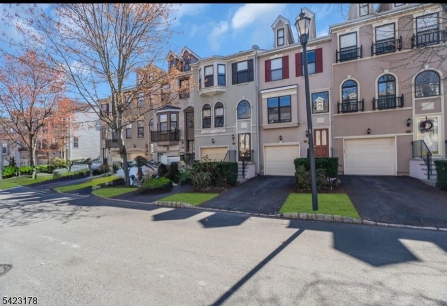 Impeccably maintained and updated Townhouse in the Prestigious Cambridge Heights Complex offering the best possible location near Shopping, NYC Bus, Dining and Schools. This amazing personal residence offers over 2000 square feet of luxurious living space with a View of the grounds and Fountain. The Main Level Features Beautiful Hardwood Floors Throughout with a Spacious Formal Dining Room with Crown Molding and Ample Natural Light, an Ultra Modern Kitchen with Granite Counters, Brilliant White Cabinets, Stainless Steel Appliances and recessed Lighting and a Gorgeous Living Room with a Gas Fireplace, Recessed Lighting and Crown Molding and a Convenient Half Bath. Upstairs you will find amazing Wood Floors, a sensational Master Bedroom Suite with a Vaulted Ceiling, Ceiling Fan, Two Huge Closets and a Spectacular Full Bath wth a Double Vanity, Soaking Tub and Separate Stall Shower, a Second Bedroom with Unique Skylights, a Ceiling Fan and an Oversized Double Closet and a Second Full Bath with a Vanity, Tub and Shower and a Super Convenient Laundry Area.  The Finished Ground Level offers a Family Room with a Second Gas Fireplace, Direct Access to the Backyard and Patio, Recessed Lighting, and Access to the attached garage. The HVAC system is newer and the unit is only Steps away from the playground. The Complex Amenities include a Clubhouse with Exercise Facilities, a Pool, Tennis Court, Lush Landscaping and Gated Security.