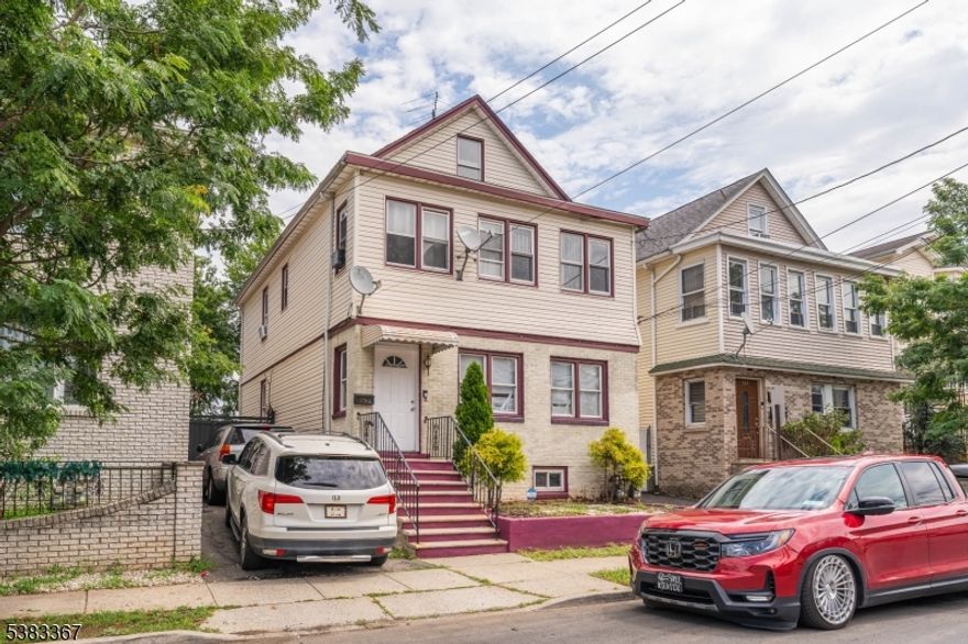 INCOME PRODUCING TWO FAMILY  with 3 bedrooms on each floor, plenty of storage in a partially finished basement and unfinished attic. Big backyard with detached garage and parking for up to 5 cars.