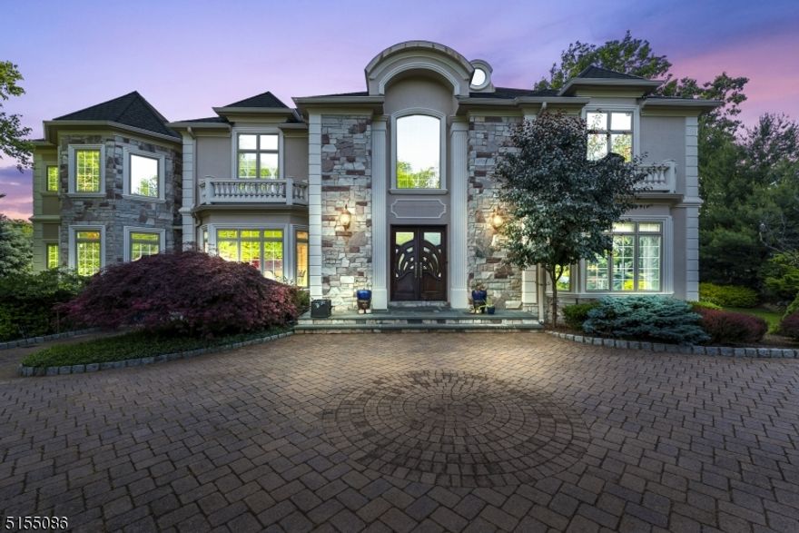 Luxury abounds in this exquisite Rio Vista masterpiece!  As you enter, you are met with a double staircase grand two story entry foyer, which is accented with meticulous moldings and trim showcasing every perfect detail. The first floor exemplifies true opulence beginning with a gorgeous great room that offers a wall of windows letting in floor to ceiling natural light and also showcases a wood burning fireplace. The kitchen features a massive island along with high-end appliances. It also features a separate dining area, opens to a family room and also leads to the concrete deck which overlooks the private wooded back yard. The attached 'Prep Kitchen' also offers high end appliances and a large pantry. Work from home or run your business out of the home office, which features a separate entrance. Also, the first floor offers an en-suite, perfect for in-law or mother/daughter set up. Enjoy night time retreats in the primary bedroom, which offers a sitting area, massive walk-in closet and a gorgeous master bath. With it's total openness, the full finished walk-out basement offers additional living space and includes an additional bedroom, extra summer kitchen, as well as a full bath and additional storage! A bonus to note is the walk-up unfinished attic, which can be finished to create even more living space.