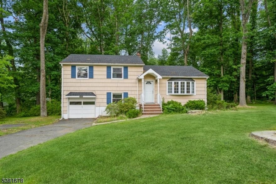 Beautiful Split Level with 3 BR and 2 bathrooms sits on nearly half an acre of park-like property in a quiet neighborhood. Enjoy peaceful privacy surrounded by nature, close to schools, shops, eateries, highways and direct train to  NYC. Spacious home features hardwood floors, bright rooms, and an open layout and versatile space for living and entertaining. A large Living Room flows to the Dinning Room and kitchen with granite counters, pantry, granite counter tops and plenty cabinets. A pass-through kitchen counter to the dining room makes entertaining a breeze. Sliders open to a deck overlooking a sprawling back yard - a perfect spot for cookouts & parties. In the second floor you can find the large primary bedroom with 2 closets, 2 additional bedrooms and a full bathroom. The ground level has a large recreation-room and a full bathroom with an outside entrance and access to a 1 car garage. The basement level offer large space for storage and laundry area. Move-in ready home on tree-lined street has it all, including a beautiful path to playground and elementary school.