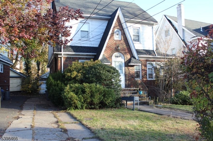 Welcome to this charming 5 bed, 2.5 bath Tudor brick home, nestled on a serene, tree-lined block. With a solid structure and striking curb appeal, it's ready for your personal touch. Conveniently located just steps from NYC express transit, dining, shopping, this home offers the best of both comfort and accessibility. As you step inside, you'll be greeted by a traditional floor plan featuring gleaming hardwood floors throughout and plenty of windows allowing an abundance of natural light to permeate the space . The separate living and dining rooms create an ideal flow for gatherings, with the living room providing a spacious space to unwind and the dining room offering an ideal space for meals and dinner parties.  In need of TLC so come, bring your ideas and imagination! Perfect for investors. Subject to bank approval. **Highest and best  Friday, December 5th at 5pm.