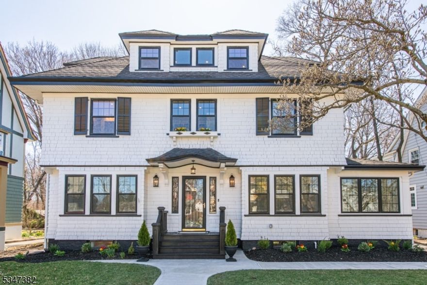This meticulously renovated 5-bed, 4 full & 1 half bath Center Hall Colonial in sought-after Erwin Park blends regal elegance with modern sophistication. The spacious, light-filled open concept main floor effortlessly integrates historic details with contemporary updates. The living room, featuring a wood-burning fireplace and French doors to a private sitting room/den, offers views of the expansive yard, while the dining room and breakfast bar invite formal dining and relaxed entertaining with friends. The custom kitchen, featuring high-end appliances, ambient lighting, ample space, and abundant storage, is every chef's envy. The kitchen has steps down to a spacious family room with views of the rear yard, a custom mudroom, a rear door for quick entry from the private rear deck, and a perfectly placed powder room. The 2nd floor primary is a true retreat, with a large walk-in closet and a richly appointed bath including a large walk-in shower for two. The third floor, filled with sunlight, includes a full bath and flex space for two additional bedrooms, a home office, or a nanny suite. The basement features a casual family room, a dedicated exercise/yoga room, wine storage/tasting room, full bath, and oversized laundry room. The deep yard, with a manicured lawn & custom lighting, is ideal for garden parties, summer naps, and star-lit evenings. Additional features include two-zone A/C, full grounds irrigation, proximity to NY transit, and the best of the Montclair lifestyle.
