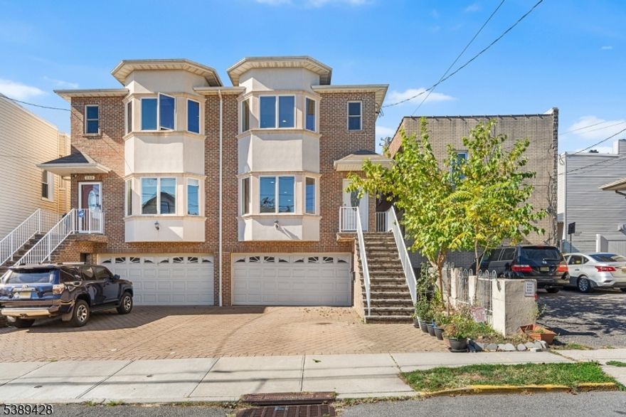 Welcome to 233 5th St Unit B, this spacious 3 bed, 3.5 bath home features hardwood floors throughout and NYC skyline views. The open-concept main level flows from the living room with a gas fireplace, then through the dining and kitchen with a private patio perfect for enjoying quiet evenings outdoors.The finished basement, complete with a full bathroom, and walkout to the backyard, offers flexible space for a family room, office, or gym. Convenience continues with in-unit laundry, central air, a paver driveway, and garage parking.Celebrate summer nights and watch 4th of July fireworks right from home! Best of all no HOA fees. Located in one of Bergen County's most commuter-friendly areas, you'll enjoy easy access to public transportation and major highways for a quick trip into NYC and beyond!