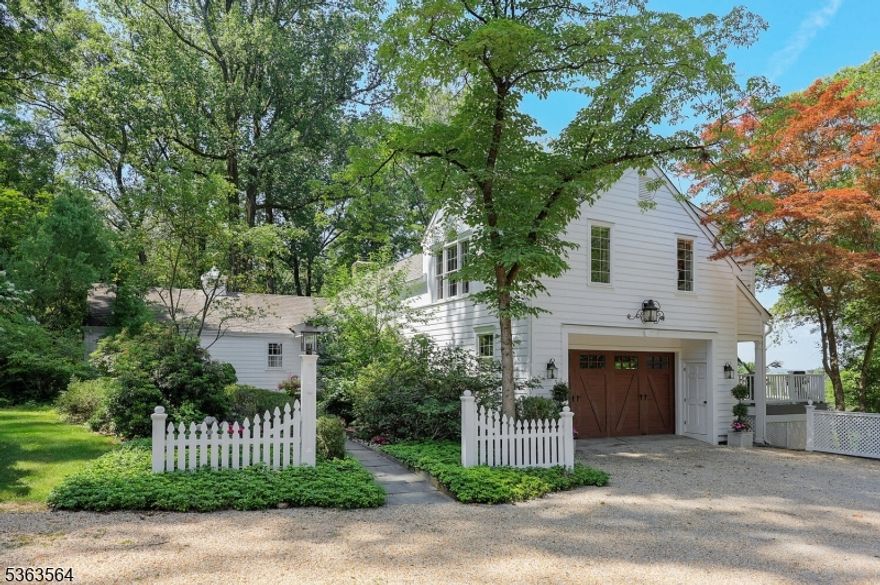 Perched atop the sought-after Bernardsville Mountain, this five-bedroom custom home offers sweeping mountain views and over five acres of breathtaking beauty. Inside, a sun-drenched living room with floor-to-ceiling windows invites the outdoors in, while the gourmet kitchen and formal dining room set the stage for unforgettable gatherings. Two ensuite bedrooms and a powder room on the main floor provide comfort and flexibility, while the entire second floor is dedicated to a luxurious primary suite featuring a spa-like bath with jacuzzi tub, stall shower, walk-in closet, and tranquil bedroom retreat. The lower level is filled with natural light and warmth, offering a cozy family room with a wood-burning fireplace, a game room with wet bar, a laundry area, and utility room. A separate private suite with two bedrooms, a sitting room, and full bath complete with its own entrance is ideal for guests. Step outside to discover a storybook setting: a welcoming courtyard with stone walls and a babbling fountain, a sprawling deck, a lower patio with fire pit, and an outbuilding perfect for a studio, office, or extra storage. Surrounded by manicured grounds and endless sunset views, this home is a true retreat where nature, privacy, and convenience come together in perfect harmony, just minutes from town, top-rated schools, and NJ Transit.