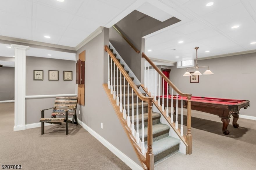 Step into luxury with this exquisite 4 bedroom, 5.1 bath home with full finished basement, situated in the tree-lined, coveted community of Canterbury Estates. A two-story foyer with gently turned oak staircase introduces the well-designed floor plan. Architectural features and statement millwork are found throughout, including the living room that has a floor to ceiling built-in. The generously-sized kitchen is the heart of the home, perfect for informal dinners or large gatherings. Stainless steel appliances, a double-length center island, & a breakfast room with tall windows combine to create the perfect setting for culinary and entertaining experiences, with seamless flow to the adjoining rooms and a second staircase. The family room features a stacked-stone fireplace, and incredible views. Celebrate special events in the formal dining room with Butlers Pantry. The office in this award-winning model is private and has box bay windows. Upstairs, the apartment-sized primary suite with volume ceiling, walk-in custom closet, spa-quality bath with frameless walk-in shower, two vanities, and soaking tub is a true sanctuary. Three more bedrooms, each with bath ensuite, complete this level. The finished basement offers a kitchenette, media and game area, full bath, and storage. The beautifully landscaped level yard is tranquil and private, complete with Ipe deck, outdoor kitchen and bluestone patio. It is an ideal space for relaxing or hosting guests. Bonus-whole-house generator.