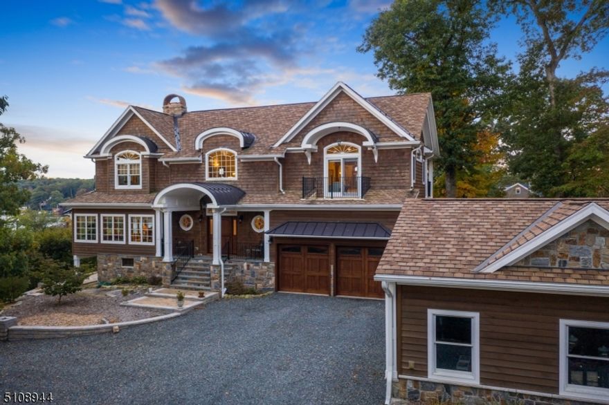 Welcome to this One of a Kind Home with breathtaking views and luxury living. This stunning home sits on over an acre of land, perched at the top of the desirable Lake Hopatcong. Upon entering the foyer, you are greeted with a grand circular oak staircase w/ a gorgeous brass chandelier. Notice the coffered ceilings, crown moldings and extensive custom millwork throughout. The attention to detail of this home is impeccable. The 1st flr boasts a subtle nautical theme with circular nautical windows, amber stone door knobs, travertine stone, and "rope knots" in the tile, backsplash, and handles. The chef's kitchen features top of the line S/S appliances, along with a large center island perfect for hosting. The custom maple cabinetry is coupled with beautiful granite counters that completes this beautiful kitchen. With the open floorplan, your eye catches attention to the living room/ dining room area that have oversized windows showing unbelievable views to the lake. Separating the LR and DR, you have a wood burning fire place that can heat the entire house through the baseboards and solid mahogany wet bar to enjoy the cold nights. Radiant floor heating throughout will keep your feet warm as well! Upstairs, there's the grand master suite with custom vaulted ceilings and two outdoor patios. Two other bedrooms located on the other side with mahogany built-ins with a connected patio to both rooms. Option for 4th bedroom on lower level. This Home is Truly one not to be missed!