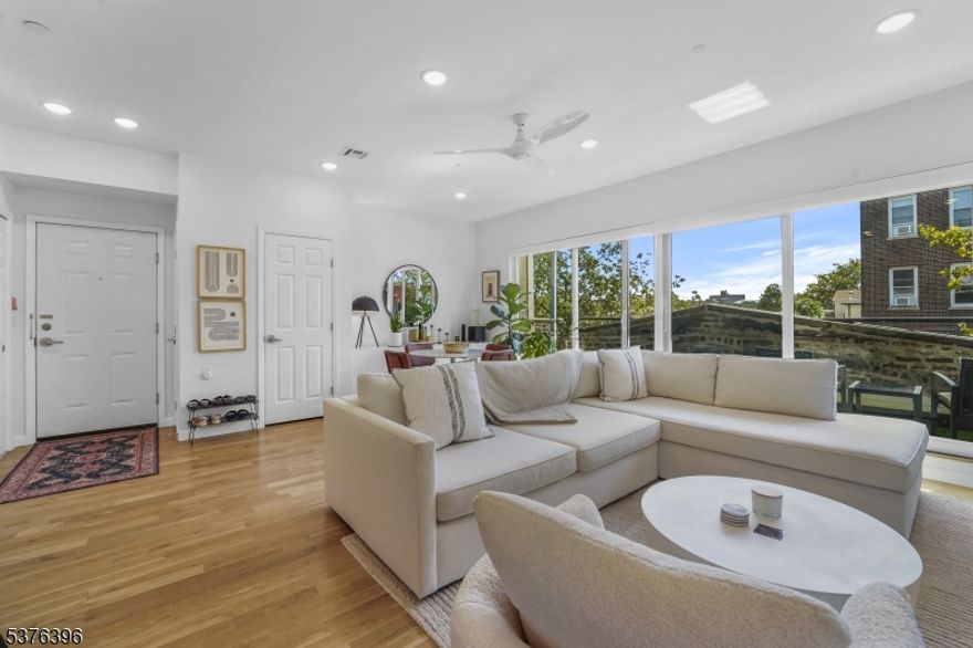 Welcome to luxury living in Jersey City! This stunning 2 bedroom 2 bathroom condo is available for leasing. Built just 3 years ago, this condo has everything you could want and more. Featuring private parking and an elevator, this condo is also in a pet-friendly building. With 1,044 square feet of living space, this home also offers a gorgeous custom kitchen with quartz countertops, a tiled backsplash, and stainless steel appliances. With an oversized breakfast bar with pendant lighting above, you can enjoy plenty of additional seating to dine. The sunny living and dining rooms are spacious and bright as the natural light from the large floor-to-ceiling windows and sliding glass door fills the space. Enjoy morning and evening views from the private terrace as well. The primary suite offers a custom walk-in closet and a luxurious full bathroom with a double-sink quartz vanity, a walk-in shower, and heated porcelain floors. Both a Samsung washer and dryer are also included inside of the unit. With gleaming white oak hardwood floors and recessed lighting throughout, this unit is modern and move-in ready. The building is complemented with a storage room and a 24/7 video security system. Conveniently located, this condo is just a quick walk to the Journal Square PATH with plenty of shopping and dining options nearby. Come see this chic and trendy gem for yourself!