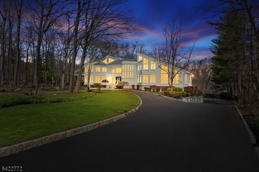 Wake up each day to breathtaking lakefront views in this striking modern home, set within the gated Smoke Rise community on one of its most coveted streets. Defined by walls of glass & clean architectural lines, the home is designed to maximize natural light, privacy, & a seamless connection to the landscape. Live and entertain with ease as the home offers: a dramatic great room with soaring ceilings and expansive windows, multiple living and gathering spaces, a chef's kitchen with high-end finishes, and a seamless flow to the rear deck overlooking the water. The lower level is designed for entertaining, featuring a custom theater, recreation space, wet bar, fitness area, & walkout access to the backyard. Outdoors, the setting has been curated with a newly installed pool, sunken fire pit overlooking the lake, and extensive hardscape, landscaping, and integrated audio, creating a private resort-like experience. Upstairs, spacious bedrooms and a stunning primary suite provide comfort and privacy, while thoughtful design and quality finishes carry throughout. The setting, lakefront lifestyle, and level of finish truly make this home one of a kind. Within this sought-after gated enclave, you'll find one of New Jersey's liveliest social scenes, with an array of clubs, dining, a beach, tennis club, sports bar, fishing, swimming, 24/7 gated security, & more. Embrace this exceptional opportunity to own a breathtaking home in an unparalleled setting. Schedule your private tour today.
