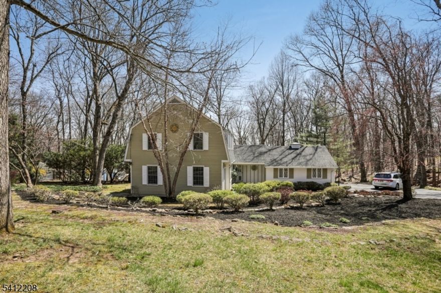 This Puddingstone Heights home offers sophisticated living on an open, wooded lot w/ private grounds. It is a thoughtfully designed home which is ideal for aging in place with modern flexibility. Main floor features an eat-in kitchen which is open to the family room. This cozy den has a focal point of a woodburning fireplace. and also opens to the deck. A formal dining room opens to the very large living room; perfect for large holiday gatherings. The generously sized bedroom/office opens to the spacious deck and is also accessible directly from the foyer.  Great for those who work from home.  It also features a a large walk-in closet and has private access to the full bathroom equipped with a large stall shower.    The back of the house faces east to allow a wash of morning sunshine each morning.  Upstairs, three additional bedrooms include a master suite, and a large converted bedroom as a double walk-in closet, and a third additional nice sized bedroom next to the hall full bath.  Hardwood in all rooms.   All three full bathrooms have been updated from original.  Finished basement for extra play/entertaining and tons of storage. Recent 2026 updates: NEW roof & AC.   The oversized two car garage is accessed via a breezeway. Future one floor living affords accessibility potential making this a versatile home for today's discerning buyer.  There is plenty of room for expansion on this acre plus property.   Highly rated school system.  Minutes from Morris Plains NJ Transit.
