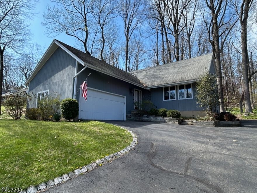 Set on a peaceful wooded lot, this custom built three bedroom home offers privacy, comfort and thoughtful updates throughout. Renovated in 2013, the home features beautiful hardwood floors, updated windows, and a stylish center isle kitchen with solid wood cabinetry, designed for both everyday living and entertaining. Spacious living and dining rooms provide a welcoming setting, while the step down family room, open to the kitchen, offers a cozy yet connected retreat with sliding doors leading to a private patio surrounded by nature. A desirable first floor office or room for guest, adds flexibility for today's lifestyle, along with a convenient laundry room with exterior access to the deck. The primary suite, also updated in 2013, features a generous walk-in closet and a well-appointed bath with a stall shower. Two additional bedrooms, updated hall bath, linen closet and attic access are located upstairs, offering comfortable accommodations. The partially finished basement includes a rec room, built-in cabinets, abundant storage and a workshop area. Completing the home is an attached two car garage and a storage shed, making this property a perfect blend of functionality, space, and serene surroundings.