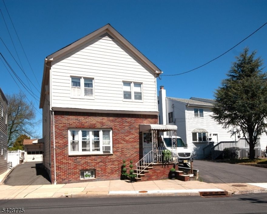 Excellent investment opportunity!  Two-Family home with half brick front, long driveway & oversized detached two-car garage.    An ideal setup offering two bedrooms in each apartment with separate utilities & entrances to an unfinished basement with washer/dryer hookups.    1st floor has high ceilings, spacious living room, renovated bathroom, updated kitchen with built-in cabinetry highlighted by a decorative tin ceiling.  2nd floor has a modern kitchen with granite countertops, stainless steel appliances and sizable living room/dining room filled with natural light.  Very close to shops, restaurants, parks, schools (Blue Ribbon district) & transportation (one mile to train station), bus around the corner.   Occupy one unit while earning rental income from the other!