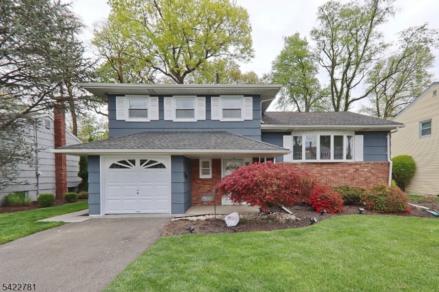 Immaculate updated home.  2 new bathrooms, updates in kitchen including new kitchen appliances, stove, microwave, refrigerator and dishwasher.  Hardwood floors thru out . Freshly painted interior and exterior. Rear sun porch and family room.  Rec room in basement with a kitchenette. Updated windows. Newer roof. Professionally landscaped property.