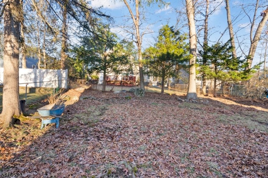 Beautifully updated and move-in ready, this inviting Wayne home offers the perfect blend of style, comfort, and functionality just a few blocks from Packanack Lake and its sought-after amenities. A bright open layout, recessed lighting, and tasteful modern finishes create a warm and welcoming atmosphere throughout. The living room, centered around a striking fireplace, flows seamlessly into the dining area and renovated kitchen featuring white shaker cabinetry, stone countertops, stainless steel appliances, subway tile backsplash, and generous prep space, making it ideal for both everyday living and entertaining. A separate family room provides additional flexible living space, perfect for relaxing, gathering, or working from home. The spacious primary bedroom retreat features a vaulted ceiling, skylight, large mirrored closets, and sliding glass doors leading to a private balcony overlooking the backyard. An enclosed sunroom offers the perfect all-season space to unwind or entertain while enjoying views of the deep, tree-lined property. The lower level adds even more versatility for recreation, storage, or a home gym. Conveniently located near shopping, dining, parks, and major commuting routes, this home is a wonderful opportunity in one of Wayne's most desirable settings