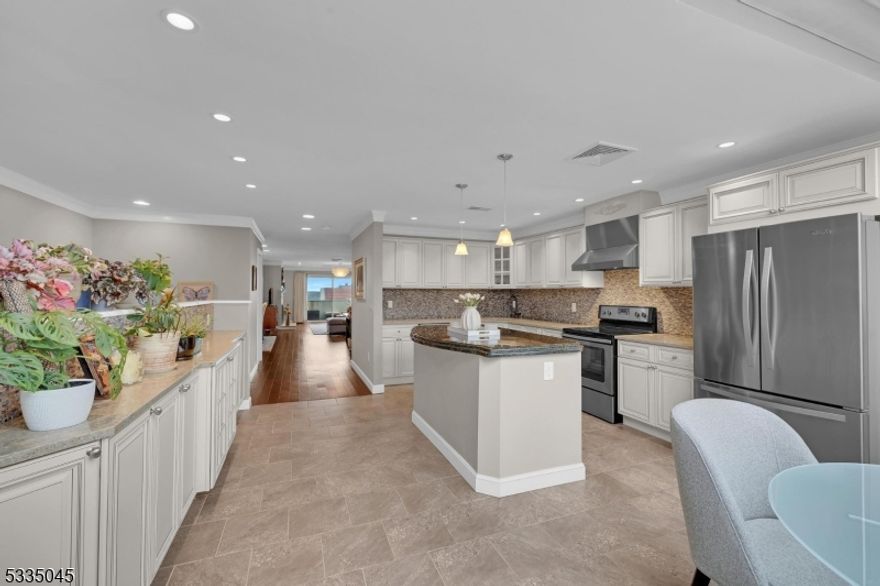 This beautifully updated unit in the Eagle Ridge community offers the perfect blend of luxury, comfort, & convenience. Move-in ready, this home features two fireplaces, wood floors, & custom glass-enclosed staircase; a true showpiece. Thoughtfully designed w/ ample custom closets throughout, it provides exceptional storage & organization.The gourmet kitchen is a chef's dream, featuring granite/quartz countertops, a stone backsplash, stainless steel appliances, a generous sized pantry, a breakfast bar, & a beverage refrigerator. An eat-in dining area boasts a custom greenhouse window, flooding the space w/ natural light. The living room showcases a stunning fireplace & sliders leading to a private balcony, perfect for relaxation or entertaining.The primary suite is a true retreat, complete w/ a fireplace , three closets (including a walk-in), & a private en-suite bath complete w/ a towel warming rack. The second bedroom also offers two closets (one walk-in) & an ensuite bath, ensuring privacy & comfort. The laundry area is thoughtfully placed on the same level as the bedrooms for effortless access. Residents of Eagle Ridge enjoy resort-style amenities, including indoor & outdoor pools, tennis/pickleball courts, a fully equipped gym, & pet waste stations located throughout the community. Conveniently located near major highways, trains & bus stations; commuting is effortless. This home truly needs nothing, just unpack & enjoy the lifestyle in this secure, gated community!