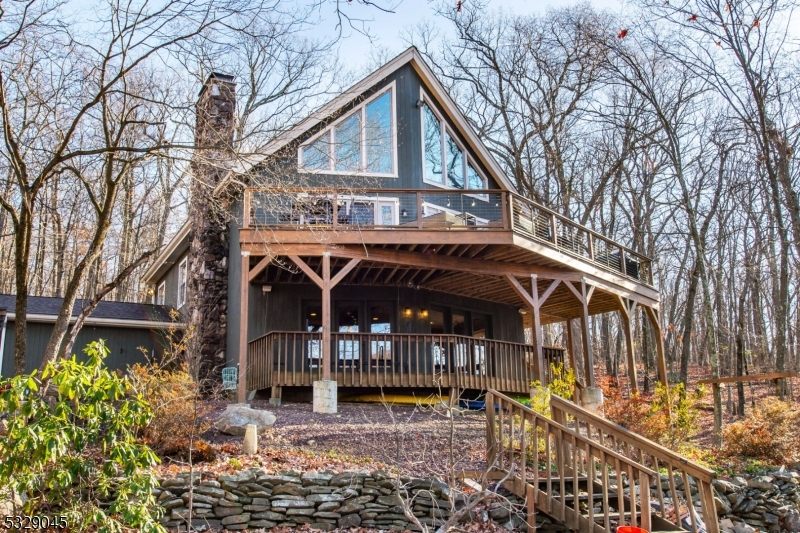 Dreamy Lake House Retreat. Just 30 Miles from NYC. Escape the hustle and bustle with this move-in-ready gem in the Kampfe Lake community. Set on a private, nearly one-acre wooded lot, this home offers the perfect lakefront lifestyle. Step inside to luxury heated slate floors on the main level, rich hardwoods like oak and hand-scraped hickory, and multiple wood-burning fireplaces, including a 2023 Lopi insert for warmth and efficiency. An open floor plan features Andersen windows and doors that flood the home with natural light and frame stunning lake and forest views. Amazing lakeside deck for relaxing and entertaining. Outdoors, enjoy direct access to Kampfe Lake from your private dock perfect for swimming, fishing, or relaxing. Adventurers will love the hiking trails leading straight into Norvin Green State Forest. Practical amenities include a two car garage, a mudroom, and a versatile bonus room for woodworking, crafts, or a home gym. Two en-suite bedrooms and a loft-style area with lake views provide a designated work-from-home space or extra sleeping options. Thoughtful upgrades include a newer roof and upgraded split system ductless A/C. The Kampfe Lake community, with only 26 homes, hosts events like the Pumpkin Float and Rock the Dock. A lakeside community gazebo adds to the charm. Expansion possibilities make this home even more appealing. Don't miss this opportunity schedule your private tour today and start making lasting lakefront memories!