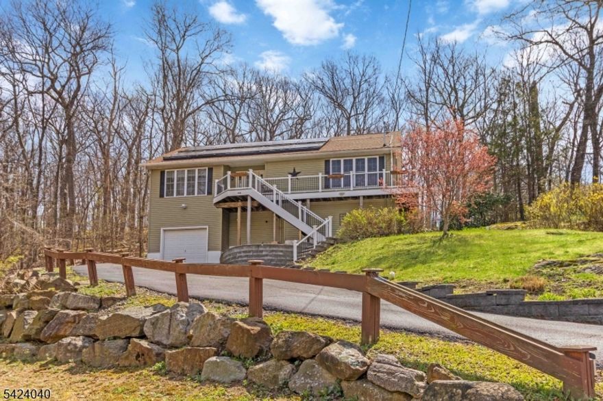 This stylish and spacious Expanded Cape offers the following Recent/New Improvements:SEPTIC SYSTEM,SOLAR PANELS,FURNACE & ROOF adding energy efficiency, long-term value & peace of mind. All this & more with a functional layout set against a beautiful backdrop of natural privacy.The 1st floor features a recently renovated kitchen w/breakfast bar & new SS range microwave & dishwasher, formal dining rm & inviting living rm perfect for both everyday living and entertaining.This level also includes a convenient powder room & a main-level primary bedroom retreat with its own full bath, providing comfort and flexibility. 1st Floor laundry area with newer washer & dryer. New gleaming laminate floors run throughout, adding warmth & continuity. Upstairs, you'll find 2 additional generously sized bedrooms & a recently updated full bathroom, offering ample space for guests, home office needs, or more. The fully finished, freshly painted walk-out basement adds to your living space with a spacious family room, a powder room, & French doors leading to the side yard, along with direct access to the garage. Step outside where you will find a large deck and a truly special private backyard with its own SAUNA, outdoor sensor lighting and security cameras, highlighted by natural exposed boulders, stone walls, & serene surroundings as the property backs to state land. The wrap-around deck with panoramic views creates the perfect place to relax & unwind. .Room sizes appx. Convenient location!