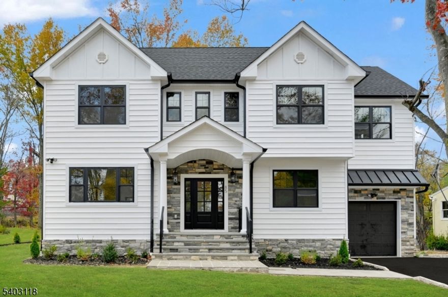 PRIME LOCATION! Walk to train, town, restaurants, schools and houses of worship. Experience timeless elegance & modern functionality in this NEWLY EXPANDED & FULLY RENOVATED 5-Bed, 4.5-Bath Colonial offering approx 3,600+ sqft. of beautifully designed living space on a FLAT 0.24-acre lot. Step into a dramatic 2-story foyer highlighted by hardwood floors, designer lighting & abundant natural light. The open-concept main level flows seamlessly into a chef's Kitchen featuring quartz countertops, ceiling-height cabinetry, a center island with seating, and Forno Appliances. A spacious living room with a gas/electric fireplace adds warmth & sophistication, while the dining room opens to a large Trex Deck, perfect for everyday living & entertaining. A first-floor bedroom/office with an adjacent powder room offers flexibility. Upstairs, the luxurious primary suite showcases WIC and spa-inspired bath with a soaking tub, glass shower, & dual vanities. 3 additional Bedrooms, 2 full Baths (including 1 en-suite), & a convenient Laundry Room complete this level.The fully finished basement expands the living space with a large recreation room, full bath & utility room - ideal for fitness, entertainment, or guests. Additional highlights include an EV charging outlet in the garage.