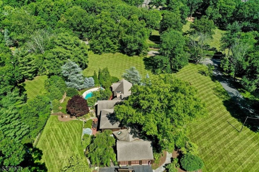 Welcome! New capital improvements added to this beautifully maintained spacious 5-bedroom, 4.5-bath home, perfectly located in prestigious Saddle River, Designed for all ages and lifestyles, this inviting property offers quiet luxury, a flexible entertainment layout, and effortless indoor-outdoor living. A brand-new 6-bedroom septic system (install 8/2025) adds tremendous value and future expansion potential. Set on 2.3+ irrigated landscaped acres, the home features two wells, a heated gunite pool with spa, surrounded by mature perennials and a natural arborvitae fence for privacy. Enjoy low taxes, whole-house smart generator, a 3-car garage, extensive storage, and close proximity of Police/Fire dept. The first floor includes a primary suite, two additional bedrooms, a full and half bath, a great room, dining room, den, and a well appointed kitchen. Upstairs, two more bedrooms share a full bath and offer step-in access to large attic storage. The lower level includes laundry (with first-floor hookup option), plus a convenient ground-level entry to a heated room and full bath, perfect for pool use or guest overflow. Living spaces flow seamlessly to a large, level, securely fenced yard that is ideal for pets, play, and gatherings. This is a rare opportunity to move right in or update to suit your vision. All within one of Bergen Countys most sought after communities and top-rated school districts. Refined suburban living with space, privacy, and lasting peace of mind.