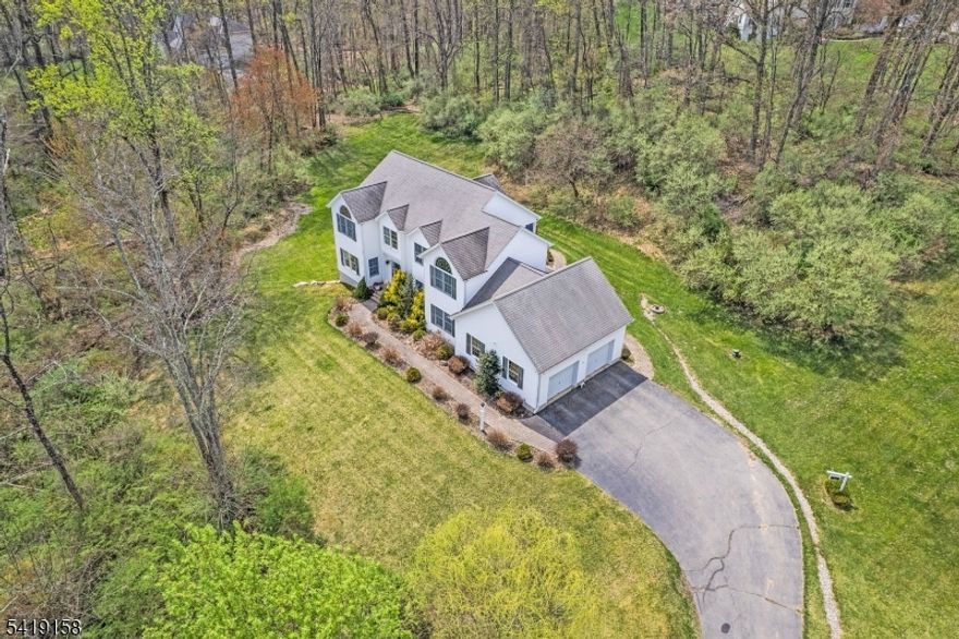 THIS BEAUTIFUL 4 BEDROOM 2.5 BATH CUSTOM CENTER HALL COLONIAL IS WAITING FOR YOUR PERSONAL TOUCHES. This custom 3,309 sq ft. home is situated on a secluded 3.64 acres property accessible from a private drive.  The main level boasts a formal dining room, a cozy living room with a fireplace also accessible from the family room, a spacious kitchen with center island, breakfast area and sliders to access your deck. The first floor also consists of a powder room,  den, and laundry room. Both have access to you oversized 2 car garage.    The 2nd floor boasts a large primary suite with walk-in closet and primary bath.  There are three more bedrooms on this floor with a 2nd full bath and 25 x 13 leisure room.   The unfinished walk-out lower level consists of high ceiling and plumbed for a third full bath.    All the space and privacy you could want and still only minutes to shopping, mass transit, and easy commute to Rte. 80 and 46.