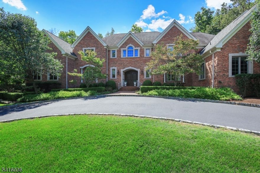 RARE OPPORTUNITY to live in one of Warren's MOST PRESTIGIOUS neighborhoods. Spanning over 8,600 sq ft across 3 finished levels, this exceptional residence is thoughtfully designed for effortless entertaining both indoors & out. Inside, a dramatic front-to-back marble foyer welcomes you w/an impressive 18-foot barrel ceiling & sweeping butterfly staircase. Gourmet designer kitchen features custom cabinetry, WOLF & SUB-ZERO appliances, leathered granite & limestone countertops, walk-in pantry, large center island w/bar seating & butler's pantry. Stunning great room is highlighted by an 18-foot coffered ceiling, striking stone fireplace & an impressive wall of floor-to-ceiling glass overlooking the private backyard. Formal living & dining rooms display exquisite millwork. FIRST LEVEL also includes a handsome library w/rich wainscoting, built-in bookcases & a gas fireplace along w/a convenient EN-SUITE BEDROOM ideal for guests. Upstairs, the luxurious primary suite features a bay sitting area & a spa-inspired bath w/radiant heated floors. 4 addt'l bedrooms & 3 full baths incl. multiple en-suite bedrooms & custom walk-in closets. Finished LL provides addt'l living space w/a gym, media room, powder room & abundant storage. Resort-style backyard features expansive stone patios, pool w/motorized cover, hot tub, spacious dining terrace & a charming POOL HOUSE W/COVERED PORCH, changing area & half bath. Whole-house GENERATOR. Close proximity to PINGRY. Beautiful, private, wooded lot.