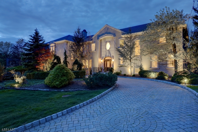 This glamorous custom designed French Manor, located at the end of a quiet cul-de-sac offers 5 BR, 6.5 BA and grand interior spaces where you will find old world charm with beautiful modern touches! Custom updated KIT a chef's dream equipped w/commercial grade appliances, center island, adjoining dining area & full BA. Ideal for entertaining throughout, from the formal DR to the exquisite 2 story GR with charming overlook, French doors provide access to the patio & pool. Custom mahogany bar, movie theatre, & wine cellar. The luxurious master w/dressing room and spa style BA housed in the west wing as well as 2 additional suites. The 2 additional BR in the east wing are spacious & comfortable. Mature landscaping providing plenty of privacy, ambient lighting & surround sound complete this outdoor paradise.
