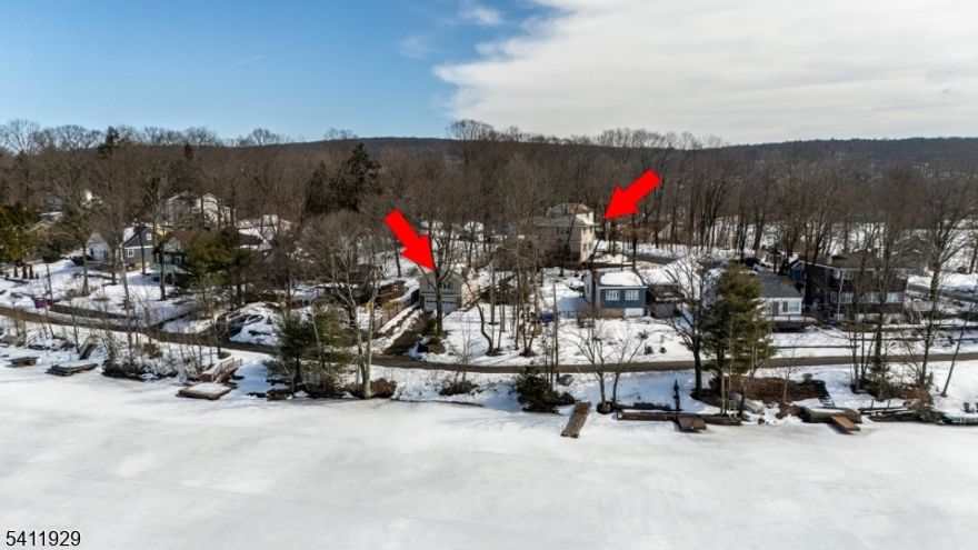 Spectacular Lake Views from nearly every angle in this beautifully positioned home in Upper Greenwood Lake. The lake is visible in three directions and the over sized two car, two story garage w/ Great room is situated directly across from the lake. The home features a spacious kitchen, formal dining room, lots of wood floors, and two impressive great rooms- one serving as the main Living area with sliders to a deck overlooking the water and also the Master bedroom. This home also offers secondary heating in case of a power loss. The Master Bedroom includes a walk in closet, hard wood floors and a tray ceiling. The upstairs main bathroom has a striking glass wall that maximizes natural light and views in the full bath. Two additional bedrooms offer flexibility with one ideal for an office on the main level. Above the oversized two car garage is a large bonus room facing the lake- perfect for a media room, playroom studio, or additional recreational space. Paver walkways, gazebo and generous parking complete this property, with space for two cars near the home and up to six additional vehicles by the garage. A Unique opportunity to enjoy expansive lake views, versatile living space, and the lifestyle Upper Greenwood Lake is known for. **THREE BEDROOM HOME WITH A TWO BEDROOM SEPTIC SYSTEM**