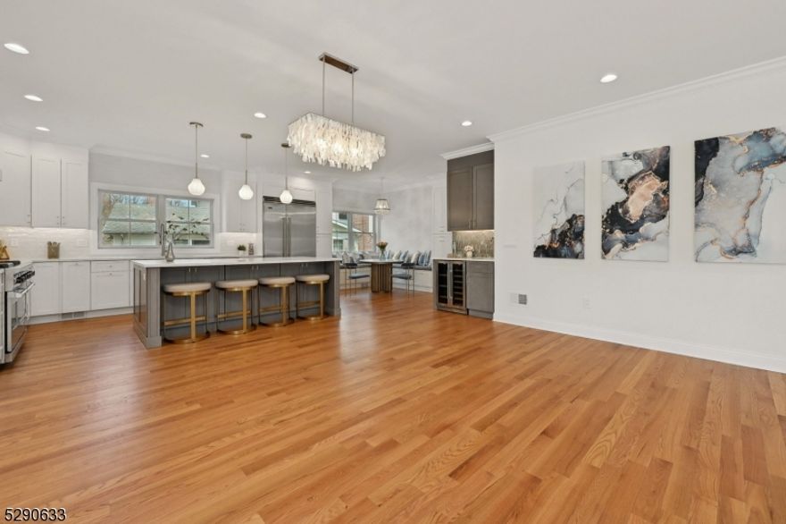 Greeted by a bright and airy entrance foyer with soaring ceilings, welcome to 42 Exeter! This stunning Modern Tudor Style new construction home in Short Hills checks all of the boxes! Featuring a grand open floor plan, the 1st floor is home to a living room, breathtaking powder room and EN-SUITE bedroom with the view of the picturesque landscaping. The Kitchen opens to the dining room and family room, serving as the heart of the house and showcases an expansive island, walk-in pantry, wine bar, Viking appliances, and elegant breakfast nook to fulfill all of your inner chef's desires. Exceptional sliding doors extend the living space to the deck, embracing all outdoor pleasure. The 2nd floor boasts 4 generous bedrooms, incl a bedroom suite with EN SUITE bath, 2 spacious bedrooms with a J&J bath, and a Remarkable PRIMARY BEDROOM SUITE with all the bells and whistles, enclosing a custom WIC, gorgeous primary bath, and an EN SUITE office, perfect for WFH or entertaining. A cheerful laundry room completes this level. The incomparable walk-out basement is mostly above the ground, incl an enormous recreation room, 2 spacious bedrooms with above-ground full-sized windows, a full bath, an expansive wine bar and tons of storage. The rear bedroom overlooks a stunning view outside, perfect for enjoying nature's beauty. Millburn's TOP Schools, Parks/Recreation, Thriving Downtown, Easy NYC Commute, Access to major highways, EWR Airport under 20 mins and MORE. 10-year Warranty!