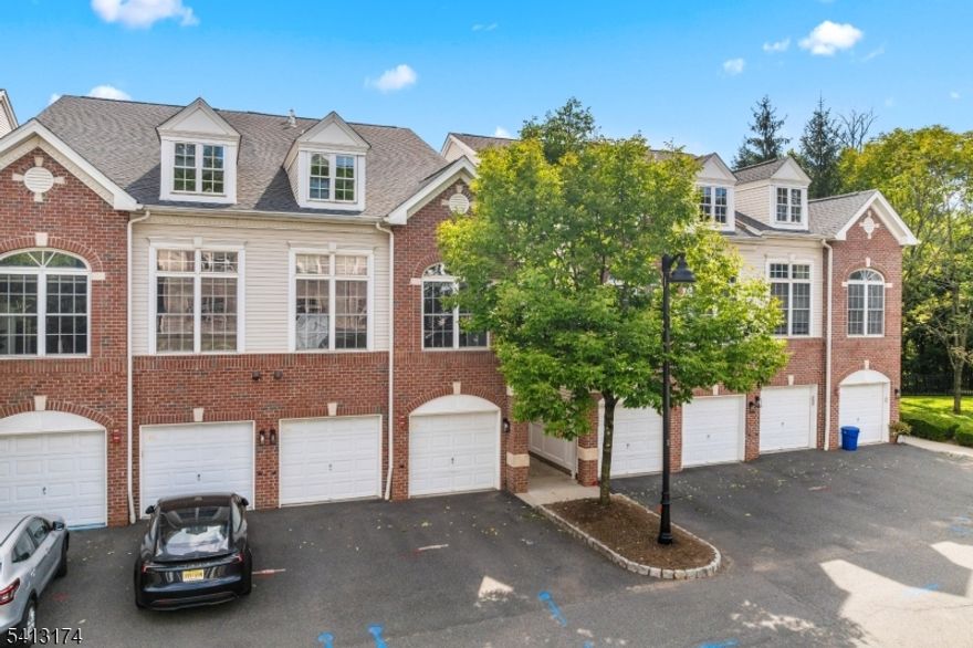 WELCOME HOME! This brick-front 2-bedroom, 2.5-bath townhouse offers a bright and open floor plan in the desirable Reserve. The 2-story livingroom features soaring ceilings, oversized windows that flood the space with natural light, and a cozy gas fireplace. The open-concept design continues with adining area and updated kitchen complete with stainless steel appliances, tile backsplash, and hardwood floors. A convenient powder room completes thefirst floor. Upstairs, a spacious loft overlooking the living room is perfect for a den or home office. The second level also includes a laundry area, secondarybedroom with full hall bath, and a luxurious primary suite with vaulted ceilings, a custom walk-in closet, spa-like bath with soaking tub, separate shower,dual-sink vanity, and sliding doors to a private balcony. Additional features include an attached 1-car garage, private driveway, fenced patio, and amplestorage. Conveniently located near Route 22 and I-78 for easy commuting, this home offers the perfect balance of comfort, style, and location.
