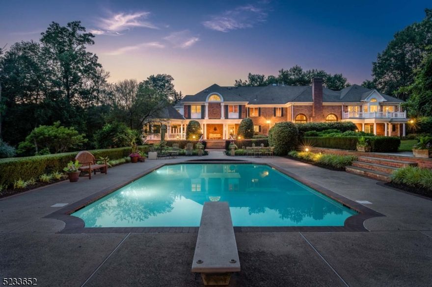 This stunning estate is being offered for the first time by the original owners. Built in 1989, thoughtful renovations and expansions were completed over the past two decades. The elegant all-brick estate is privately set on 3.45 professionally landscaped acres at the end of a quiet cul-de-sac. The resort style setting enjoys terraced manicured lawns, formal gardens and a beautiful pool and spa. There are expansive open and covered terraces for outdoor entertaining and relaxation, a covered pavilion with fireplace, a tennis court and putting green. Defined by impressive architectural details inside and out, there are three levels of comfortable living space, beautifully designed to enjoy large or intimate gatherings. There is a spacious gourmet kitchen that opens to the great room and family room. The foyer is flanked by the living and dining rooms and the handsome library enjoys a full bath. Exceptional millwork and hand painted murals can be found throughout. Over 10,000 square feet of living space includes five bedrooms, five full and one half baths. The expansive walkout lower level showcases the same level of detail as the rest of the home with a lounge area, billiards room, gorgeous entertaining bar, wine cellar, gym, theater, a bedroom and full bath. The flexible floor plan is ideal for multi-generational living! Nearby are excellent schools, easy proximity to I-78, Newark Airport and under 35 miles to NYC