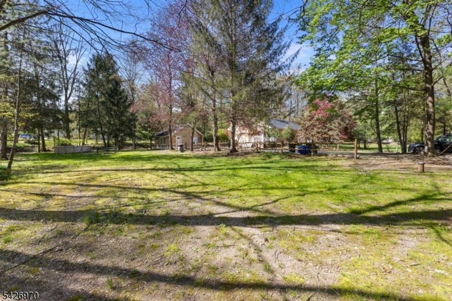 Excellent location surrounded by significantly higher-value homes. This well-maintained 3 bed rm 2 full bath ranch home offers endless possibilities and the opportunity to build your dream mansion. On approx. 1 acre in a desirable peaceful setting with excellent blue ribbon schools, dining, shopping and recreation. Hardwood floors throughout the house. Recent upgrades including new heating system, new well and whole house is freshly painted. The property features an exceptional bonus studio apartment with kitchenette, full bath and separate entrance. Ideal for guests or rental income opportunities. This is a true gem!