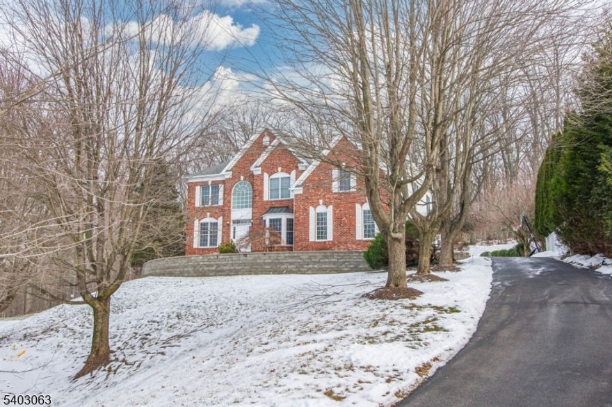 Stunning brick-front Toll Brothers Colonial set on a quiet cul-de-sac lot in prestigious Wyndham Pointe in Flanders! This elegant 4 Bedroom 3.1 Bath residence offers an expansive open floor plan with over 4100 Sq Ft of living space highlighted by a welcoming 2 story foyer, a dramatic two-story great room, soaring ceilings, crown moldings, tray ceilings, and gleaming wood floors throughout the first level. This gorgeous home features a private 1st floor office with built-ins, beautiful formal living room and dining rooms, a spacious gourmet kitchen with granite countertops, center island, and breakfast bar, a stunning sun-filled sunroom with walls of windows overlooking the picturesque landscape, a powder room and large laundry room. Upstairs, the luxurious Primary Suite is a true retreat with double-door entry, sitting area, spa-inspired bath with jetted tub, and fabulous oversized walk-in closet. The second level also offers a princess suite with en-suite bath, two additional large bedrooms, another full bath, and an open hallway bridge overlooking the main living space. A full poured-concrete basement offers endless potential for future finishing. Enjoy the private yard with beautiful masonry patio overlooking the tree-lined property and picturesque views of the majestic parklands beyond the fantastic grounds. Ideally located near Mt Olive's award-winning schools, Turkey Brook Park, shopping, & commuter routes, this is a sensational home You absolutely do not want to miss!