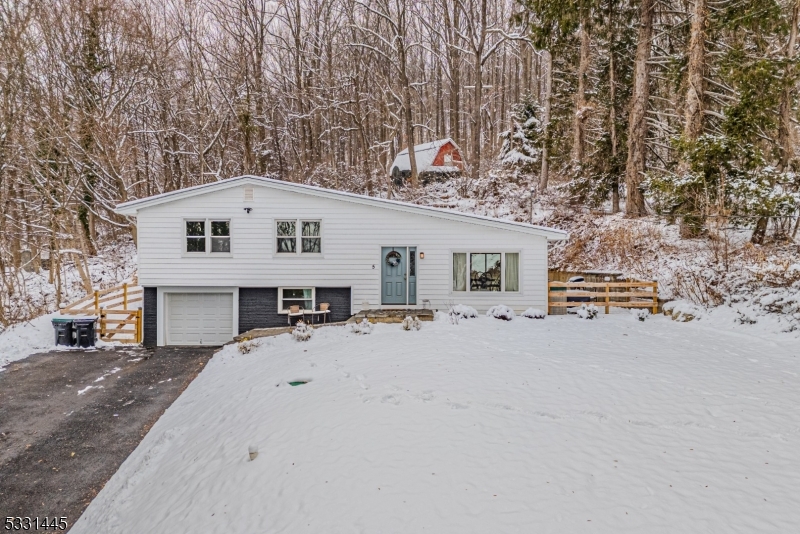 Step into this beautifully renovated split-level home in Washington Township, where modern upgrades meet comfortable living with EVERYTHING NEW. This 3-bedroom gem features a brand-new kitchen with a center island, granite countertops, and stainless steel appliances. The bathroom has been fully updated, and additional renovations include new windows and doors, roof with ice shield, siding, walkway, and driveway all ensuring a move-in-ready experience.  Enjoy a cozy finished basement, a versatile rec room, and a convenient laundry room. Freshly painted interiors, ceiling fans in every room, and a new crown boiler and water heater add to the home's appeal. The private backyard offers serene mountain views, all within proximity to Warren Hills Regional High School.  With a new radon fan, an attached garage, and a great location close to everything, this home is the perfect blend of privacy and convenience. Nothing to do but unpack!