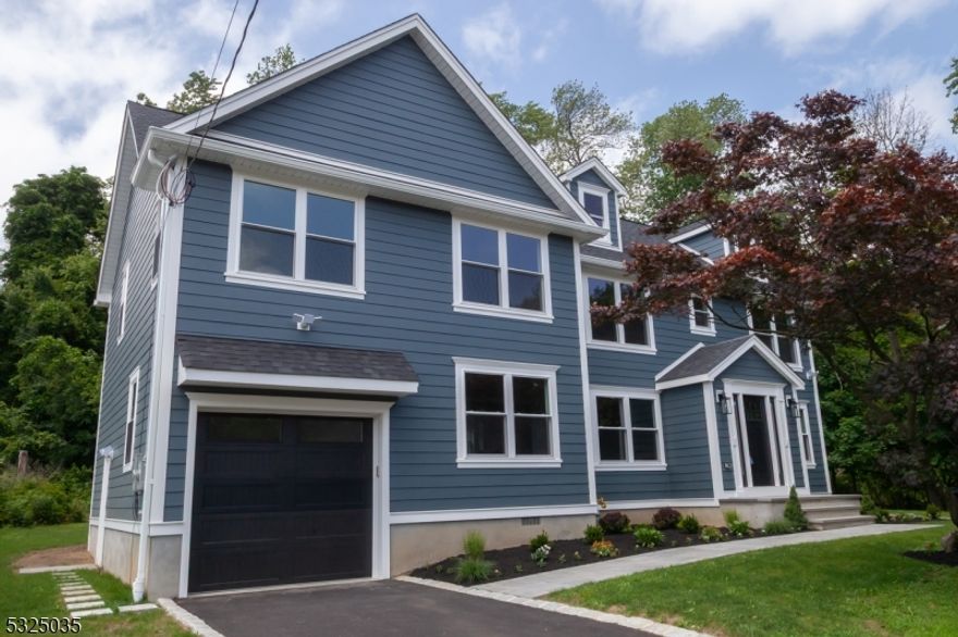 Beautiful new construction Colonial over existing foundation on a quiet private dead end in Rockaway Twp. Great location close to mall, Rt 80, & downtown. Yet located on a dead end that backs to protected woods that cannot be developed. Exterior feat Hardiplank siding, Pella windows, and a paver patio. The interior features hdwd floors throughout & marble tiled baths. Recessed LED lighting everywhere. Lower level features an open floor plan with a large LR, DR, Kitchen, a guest bedroom, office, and a full bath. Upper level has 4 bedrooms and 3 full baths. The primary & one bedroom have en suite baths, with a hall bath serving the other 2 BRs. The primary BR has 2 walk-in closets with built-ins & a master bath with double sinks & huge walk-in shower. The kitchen features quartz counters, soft-close cabinets and drawers, recessed and suspended lighting, stainless appliances, and a huge center island. All the baths have quartz-topped vanities and marble tile floors. The lower level also features a full bath and 2 flexible extra rooms. One has a closet and could be utilized as a 5th bedroom or guest bedroom, or even a home office. The other could also be used as a den, office, hobby room, etc. The home is located on a nice quiet private dead end and is serviced by city water, sewers, and natural gas for heat, hot water, and cooking.  RECEIVED MULTIPLE OFFERS:  FINAL & BEST DUE TUESDAY, JULY 15TH AT 5 P.M.