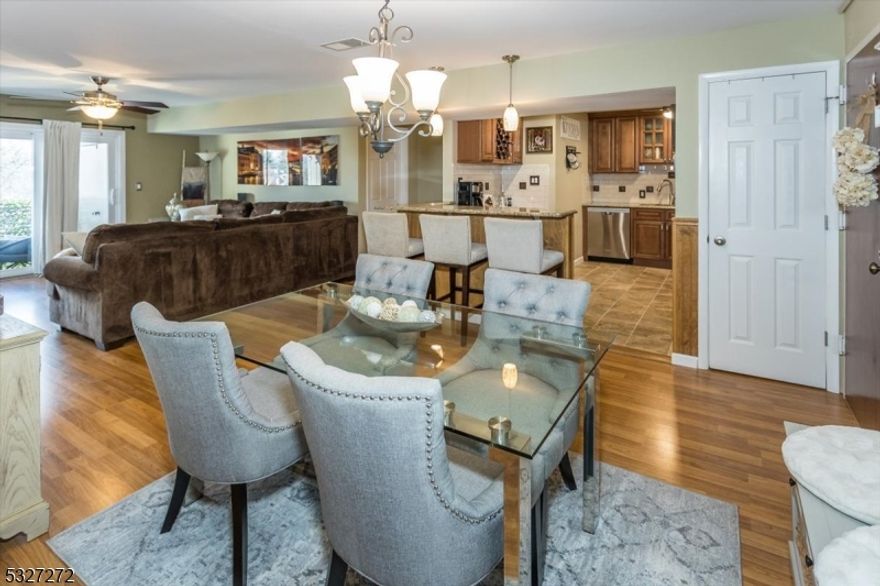 In town living at its best! So close to all the action in Morristown center yet set back on a hill that backs to state parkland for privacy & peace. Beautifully renovated in 2015, this 2 bed 2 bath 1 floor unit faces southeast so you can enjoy a bright sunny exposure  Attention to detail throughout! The Kitchen was redone in 2015 with granite countertops, wood cabinets, tile flooring & stainless steel appliances  Both baths redone in 2015 with tile flooring and quartz countertops.  Primary suite has 2 closets and a full bath with an amazing walk in shower and new glass doors installed in 2024. Newer laminate flooring throughout makes for easy cleanup.  The deck is protected on all sides with a ceiling so you can enjoy the newer tiled flooring and privacy screened railing.  All the windows and sliding glass doors replaced in 2015. The front of the building has new paver gardens to be landscaped in 2025. There is a gym for residents to use at no extra cost. Parking is rare & often an extra charge in many of the Morristown complexes.  Parking is free here with a  2 car maximum per unit;  one parking space assigned and one is first come first served. Lobby is secure and can only be entered if buzzed in from resident or with a key. The building has an elevator and additional storage for each unit is on the lobby level. Close to Rte 287, 202 and 10. Come enjoy the town's dining, theater & mid town train direct to NYC.. Then enjoy quiet living so close to town.