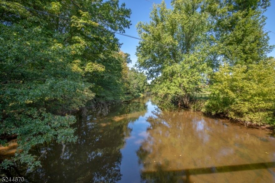 " BY THE RIVER FARM" Once roamed by the Lenape, this idyllic farm of 107 acres is being offered for the first time in 100 years. The acreage includes 87 acres of preserved farmland and 2 separate unpreserved lots, one has 14.01 acres and one has 6 acres. Surrounded by horse farms and preserved land, and near horse trails, the property features mountain vistas, open fields and 1200 ft of frontage on the Rockaway Creek. As a sportsman's paradise, it is ideal for hunting, fishing and grazing your animals in the fenced pastures. An '80's era 2 bedroom, 2 bathroom farm house has been newly painted and the wood floors throughout, refinished. The living room, with a high ceiling and towering brick fireplace, has 4 French doors which open onto a deck overlooking stone walls and farm fields.   The large eat-in kitchen, with many windows that take advantage of spectacular sunsets and views, can accommodate a seating area .  A close by 30x20' office building includes a full bath, kitchenette and large second floor for storage or additional office space and electric baseboard heat. An antique barn of peg, post and beam construction is sold As-is. Farm house chimneys sold As-is. No known issues.  A 3 bedroom septic will be installed prior to closing. This magical property is a distinctive and rare opportunity. Listing Realtor is a relative of property owner. 50 commutable miles from NYC. Close to farm stands, restaurants and shops. Minutes off exit 26 of Route 78