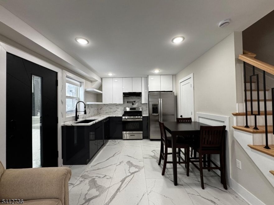 Welcome to 97 Irving Street ? a rare opportunity to live in a beautifully designed, newer construction 1-bedroom, 1-bath carriage house in the heart of Jersey City Heights.This unique two-level home offers a private entrance and an open-concept main floor that seamlessly connects the kitchen, dining, and living areas ? ideal for both everyday living and entertaining. The kitchen features custom shaker cabinetry, quartz countertops, and a GE stainless steel appliance package. High-end finishes throughout include 10-foot ceilings, 8-foot doors, Anderson 400 series windows, oak flooring, and detailed base and crown moldings. Upstairs, the spacious bedroom includes a walk-in closet and direct access to a well-appointed full bathroom. Central heating and cooling provide year-round comfort.  Located just moments from shopping, restaurants, parks, schools, and convenient transportation options, this home offers the perfect balance of privacy and accessibility.  If you?re looking for quality construction, thoughtful design, and a prime Heights location ? this is it.  Schedule your private showing today.