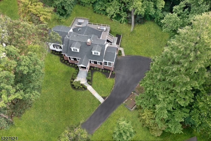 Fabulous and spacious Custom Home located at the end of a quiet cul de sac on over an acre of stunning property with loads of recent upgrades and renovations! Perched gracefully on magnificent property,  this sprawling home is 2 blocks to Hartshorn Elementary featuring convenient 1st floor Primary Suite, renovated Lower Level with Full Bath, updated Sunroom + new Trex Deck with built-in fire-pit. Open and functional floor plan with great flow - front-to-back formal Living Room with statement fireplace and direct access to Sun Room / Office with custom retractable windows and access to new Trex Deck. Family Room with vaulted ceiling completely open to Kitchen with high-end appliances, walk-in Pantry, center island + Breakfast area. Formal Dining Room leads to Dining Room. Private Primary Wing features walk-in closet, dressing area and Full Bath. Updated Powder Room and Laundry Room complete main level. 2nd level boasts 3 generous bedrooms + 2 full baths. Magnificent NEW Lower Level with Full Bath, Rec Room and Media Room with bar. Out of this world property and backyard features a spectacular new Trex Deck with LED light posts and new custom fire-pit with beautiful hardscaping. Flat, level grassy area is ready for play or relaxing enjoyment of nature's surroundings! This extraordinary home is turnkey ready for the Short Hills buyer seeking an updated home on phenomenal property close to top-notch Millburn schools, restaurants, high-end luxury shopping and NYC transportation!