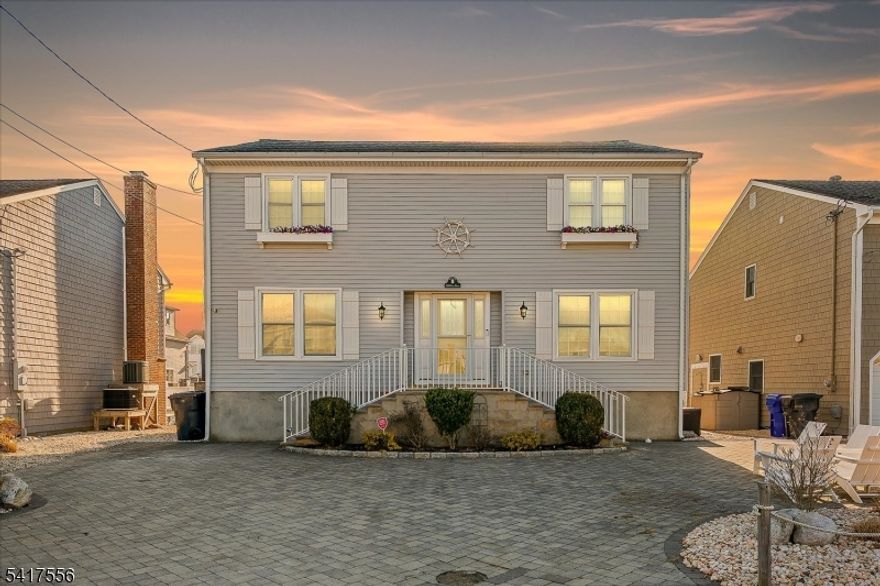 Nestled in coveted Mantoloking, this 5bed, 2.5bath lagoon front retreat has it all. The charming paver driveway sets the tone for everything this home has to offer. Step inside to a bright, open-concept living & dining area designed for easy coastal entertaining. Whether you're hosting a summer gathering or a quiet evening in, the flowing layout keeps everyone connected. Outside, the enclosed deck invites you to soak in the tranquil lagoon views, every moment here feels like a getaway. Rinse off after a day on the water with the outdoor shower. With direct access to Barnegat Bay, bring your boat, jet skis, or simply cast a line. And when the ocean calls, you're just a short stroll to the beach. Opportunities like 308 Cove Dr don't come along often, don't miss your chance to make it yours.