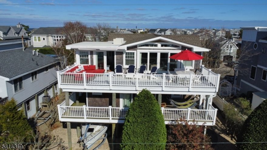 Welcome to this stunning 4-bedroom, 3.5-bath shore retreat located in the heart of Harvey Cedars in the highly sought-after Kinsey Cove neighborhood. Designed with effortless coastal living in mind, this beautifully maintained home has been thoughtfully updated with today's on-trend colors and finishes, creating a bright and inviting atmosphere perfect for relaxed shore living and entertaining alike. Multiple decks offer wonderful spaces to unwind while enjoying bay views and refreshing coastal breezes, whether you're starting the morning with coffee or gathering with friends after a perfect beach day. The home's comfortable layout was designed for memorable nights at the shore, offering generous living spaces and a seamless indoor-outdoor flow. Ideally located in the center of Harvey Cedars, you'll enjoy easy access to beautiful beaches, wonderful local restaurants, the local favorite - Neptune Market, charming shops, and all the small-town coastal charm this beloved LBI community offers. Spend the afternoon exploring the nearby historic Barnegat Lighthouse, biking along scenic streets, or enjoying sunsets along the bay. Additional highlights include a spacious two-car garage perfect for parking, storage, or extra recreation space, a paver driveway, convenient outdoor shower, and updated mechanicals providing comfort and peace of mind. Every detail has been thoughtfully considered in this exceptional home. You will love calling this Harvey Cedars gem your own.
