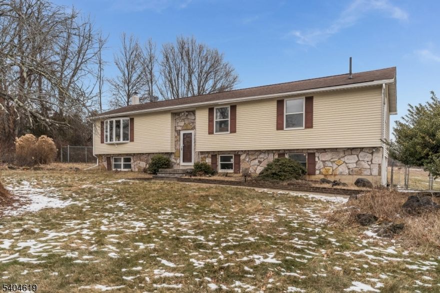 Lovely , meticulous and spacious home set on almost 2 acres of open land. Open concept Living Room which flows into the lovely kitchen with huge center island. Granite counter tops, loads of counter space and cabinets. Deck ( that overlooks the expansive yard) is right off of the kitchen . Down the hall are the 3 large bedrooms, Primary with its own bath, then 2 others featuring hard wood flooring. The second bathroom is on this level too. Downstairs is a Family Room and another room and another full bath. All 3 of these rooms have had renovation started but not complete. Buyer to complete the work. All necessary materials are included. Laundry is located on this level also. Also included is a generator hook up . As you drive up to this home you will be impressed with the setting and the picturesque neighborhood. At this time there is not a sign in the yard as the ground is frozen