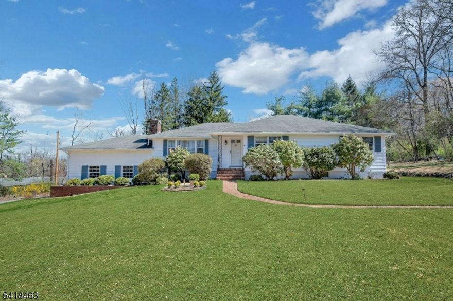 Welcome to this beautifully maintained ranch-style home set on a picturesque three-quarter-acre property. Surrounded by gorgeous landscaping and a maintenance-free Trex deck, this home offers both charm inside and out with easy living. Inside, you'll find a bright and inviting layout featuring featuring beautiful hardwood floors throughout. The living room is highlighted by a cozy fireplace, creating a warm and welcoming space to gather. The light-filled sunroom provides the perfect place to relax and enjoy the scenic views year-round. This home offers three spacious bedrooms and three full baths, including a comfortable primary suite with its own ensuite bath and direct access to the deck-ideal for morning coffee or evening unwinding. The two additional bedrooms are complemented by a beautifully updated bathroom with a skylight, filling the space with natural light. The lower level expands your living space with a full bath and a wonderful recreation space-perfect for entertaining, relaxing or flexible use. Additional highlights include two separate driveways-one leading to the attached garage another providing added convenience and flexibility. Conveniently located near RT 78, & Rt 287, and NJ train and bus service. A wonderful opportunity to enjoy single-level living in a serene and beautifully landscaped setting.