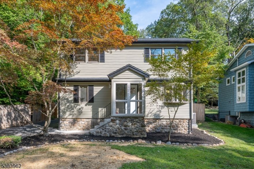 Welcome to this charming and fully renovated Cape Cod in the desirable Rock Ridge community of Denville, NJ. This 3 bedroom, 2 full bath home has been professionally updated with high-end finishes and modern amenities, blending classic charm with contemporary living. Step inside to an open concept living space that flows into the stunning, light filled kitchen. The gleaming hardwood floors and white walls create a bright and airy feel. The kitchen features brand-new stainless steel appliances, a sleek island with a deep sink, white shaker cabinets, and beautiful dark granite countertops. This open layout, complete with recessed lighting, skylights, and cathedral ceilings is perfect for entertaining and everyday life. Enjoy the outdoors from the enclosed porch, which offers a comfortable space to relax and overlooks the beautifully maintained yard. The home also includes a nice sized backyard with a shed for extra storage. This home has been completely transformed from top to bottom. It features central air, all public utilities and is minutes to downtown Denville with convenient access to highways, NJ transit, and top rated schools. Rock Ridge Lake offers a clubhouse, beach, swimming, and boating facilities, along with nearby hiking trails.