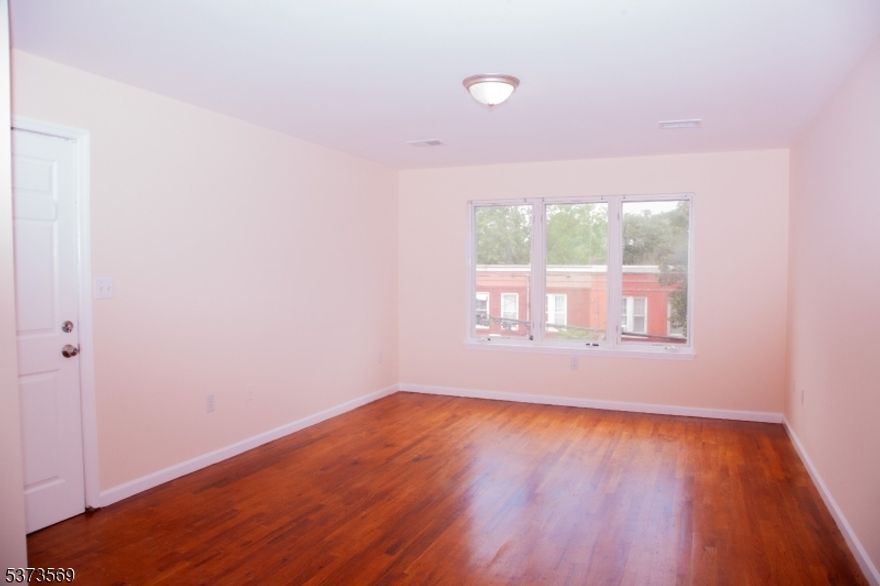 Located in the heart of North Newark, this spacious 3-bedroom, 2-bathroom apartment offers comfort and convenience. Step into a bright, sun-filled living room with ample space for both relaxing and dining.  The kitchen features stainless steel appliances and offers ample cabinet space.  The primary bedroom features two closets and a private ensuite bathroom. Two additional bedrooms share a well-appointed main bathroom  .A separate laundry room with washer and dryer hookups adds convenience to your daily routine.  The unit includes one parking space in the driveway, with additional street parking available.Conveniently located near Route 280, Route 21, the New Jersey Turnpike, and public transportation for easy commuting. Don't miss this great rental opportunity in a prime location!