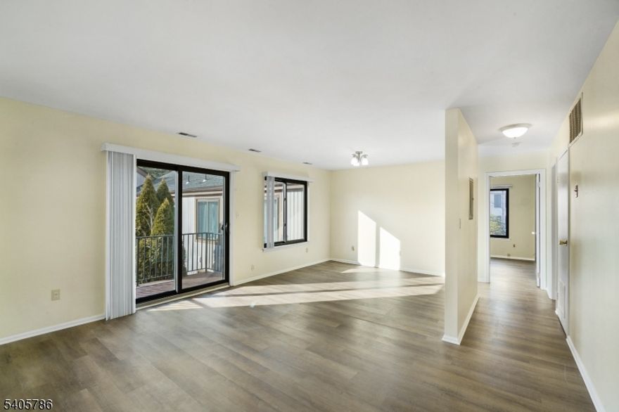 Beautifully updated 1-bedroom, 1-bath unit nestled in the serene High Point community of Stanhope, offering the perfect blend of peaceful living and everyday convenience. This light-filled home features a spacious living space with sliding glass doors that lead to a private deck, ideal for relaxing and enjoying tranquil views of nature. Stylish luxury vinyl plank flooring flows throughout. The large bedroom includes a walk-in closet with built-in shelving, while the fully renovated bathroom is thoughtfully designed with brand-new fixtures, a sleek modern vanity, and a water-saving, energy-efficient toilet. The eat-in kitchen provides ample space and includes a new stove and microwave, along with a newer refrigerator. Enjoy the convenience of in-unit laundry, making everyday living effortless. Additional highlights include a large private storage room, new boiler, and central air. Residents enjoy access to desirable community amenities such as an outdoor pool, clubhouse, playground, and community garden. All of this in a quiet, scenic setting just minutes from major commuter routes, shopping, dining, and local schools making this property as convenient as it is peaceful. This move-in-ready home offers the lifestyle you've been waiting for don't miss your chance to make it yours.