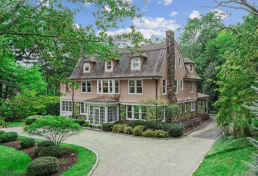 Luxurious modern amenities and updates meet early 20th century architectural integrity and exquisite details! Meticulous top-to-bottom renovated and expanded colonial located in Old Short Hills' iconic Historic District. Endless options for entertaining whether it be intimate dinner parties or large holiday gatherings, this incredible custom home has it all. Luxury finishes throughout feature intricate millwork, paneled walls, high ceilings, paired windows and fireplaces. Pristine property rests on approx 2/3 acres conveniently located just blocks to Short Hills Train. Circular driveway leads to glass-enclosed vestibule with access to bluestone patio and inviting foyer. Formal Living Room spans from front-to-back transitioning to light-filled Office/Sunroom. Formal Dining Room leads to Butler's Pantry, 2nd staircase and Chef's Eat-In Kitchen with granite counters, workspace, high-end appliances, oversized island + enormous breakfast area leading to Family Room with wall-of-windows plus French Door leading to expansive bluestone patio and private yard with lighting. Primary Suite with fireplace, dressing area, 2 walk-in closets, Sitting Room + Bathroom with radiant heated marble floors, dual vanity, soaking tub and shower. Junior Suite, 2 more bedrooms, Laundry Room and Full Bath complete 2nd floor. Spacious 3rd level with loft area, 3 more bedrooms and 2 full Baths. Lower level Rec Room with dry bar, Media Area, 2nd Laundry Room, Wine Room, half Bath, storage & yard access.