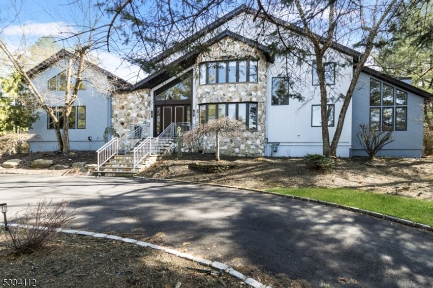 This is THE ONE that has it ALL!  LOCATION MATTERS: 1/2 Acre on one of RIKER HILL's Most Prestigious Streets. SIZE MATTERS: This 6 Bedroom, 5 Full bath + One half bath home boasts approx. 6500 sq ft of Living Space incl Finished Basement plus 3-car Garage. STYLE MATTERS: Forever-in-Demand Custom CONTEMPORARY known for its GREAT ROOM with 25 ft CATHEDRAL Ceiling, Gas FP and Tons of NATURAL LIGHT.  Home Features an Impressive 600 sq ft Chef's BRIGHT KITCHEN with10 Ft Long Quartzite TWIN Islands, Gourmet Wolf/Subzero SS Appliances (incl. 3 ovens and 2 Dishwashers) Open to LARGE Family Room with 2nd Gas Fireplace and Multiple Sliders flowing out to Expansive TREX Deck and STONE Patio. Main Floor Bedroom/Office and Full Bath perfect for MULTI-GENERATIONAL Living.  HUGE 1200+ Sq Ft MASTER EN-SUITE with NEW SPA-LIKE Bath, Double-Sided Fireplace, 2 WIC,  2nd Laundry and Sitting Room/Office. Separate "wing" includes 3 Bedrooms and 2 RENOVATED Baths.  FINISHED BASEMENT incl Rec Room,  Bedroom #6, FULL Bath, Exercise Room, Laundry #2 and TONS of Storage.  Additional Highlights: Main Floor Brazilian Walnut floors, 5 SLIDERS out to DECK/PATIO,  Whole House GENERATOR, Built-in Speaker system, Tesla Wall Charger, new driveway and much more!!  This is a VERY SPECIAL Property with spectacular SUNSET VIEWS backing up to COUNTY PARKLAND!