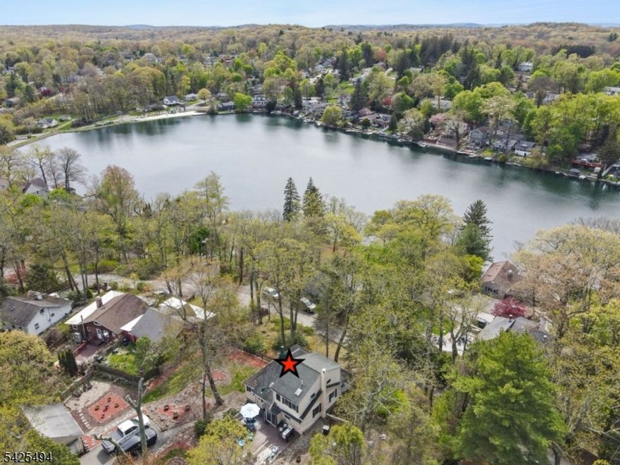 NEW PHOTOS ARE HERE! Vacation every day w/ peaceful lake views & a short walk to highly desirable Lindy's Lake beach- a private spring fed lake of 20+acres. The value here is in the location & spacious double lot size. You need to experience this property in person to appreciate it! Charming expanded log home features high ceilings, open living, stone fireplace, lots of natural light, 2 lg bedrms & tons of storage on .57 acre of picturesque yard.  Perfect to move in or great expansion potential on this sizable lot. The inviting interior blends rustic charm with an open warm feel. Step outside to a storybook garden backyard that calls you to relax in tranquility or crank it up as the yard is designed for entertaining w/multi outdoor gathering areas. A walkout partial basement provides added storage & more potential. A det 2-car garage (needs repair) offers potential for studio, home office, workshop, guest space or expansion. Lg driveway PLUS extra parking (enters frm Hudson Dr) Double lot size offers space & lots of potential. A unique opportunity w/storybook charm, space, tranquility & endless possibilities all with a short walk ( less than .2 miles) from Lindys Lake Beach. Approx 41 miles from NYC w/commute options.Value is this LOCATION AND a rare DOUBLE LOT SIZE PROPERTY. Home sold as-is.FP/chim/flue is as is-no known issues. Every day is vacation in this lovely home & lake community! Lindys Lake offers beach, boat/kayaking,fishing & many events including a Polar Plunge!