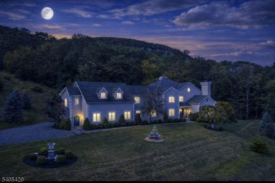 Set on over 7 acres with sweeping views, this approximately 6,000 sq. ft. custom-built French Normandy?style home is truly one of a kind. No other home in the area compares to the craftsmanship, scale, and architectural detail found here.Constructed of solid masonry and stucco, this impressive residence features four bedrooms and 4.5 baths, a three-car attached garage, and soaring ceilings throughout. The elegant living room showcases a custom imported marble fireplace and stunning French doors that open to a private stone patio, perfect for entertaining or quiet relaxation.Additional highlights include a formal dining room, a generous eat-in kitchen with stainless steel appliances and granite countertops, double ovens and refined finishes at every turn. High ceilings and exceptional design create an open, grand atmosphere while maintaining warmth and sophistication.A rare opportunity to own an architectural masterpiece offering privacy, views, and timeless European elegance ? truly unlike anything else on the market.