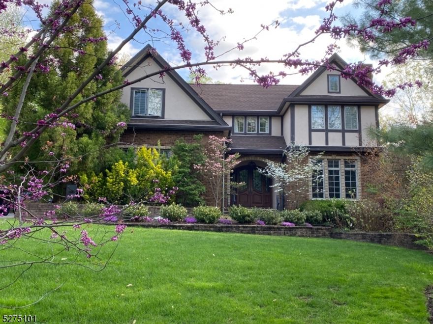 This beautiful brick custom home is located on a large level private landscaped property in the upper Wyoming historic section of town. The current owner built it for himself and spared no expense. The ironwork on the front entry and banisters were custom made by an artisan as well as the unique hanging chandeliers. The Neff kitchen has 16' ceilings, skylights and top of the line appliances. The large family room is conveniently located across from the kitchen which has outdoor access. The home's details are meticulously executed from the en suite bedrooms with heated floors in the bathrooms to the soaring 10' height of the ceilings-the attention to detail is obvious. The lower level offers a state of the art media room, a large flex space that could be a workout room, in law suite or rec room and a well appointed wine room.